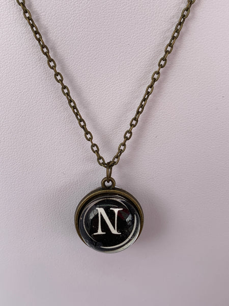 Double Sided Letter Necklace White Text on Black Background