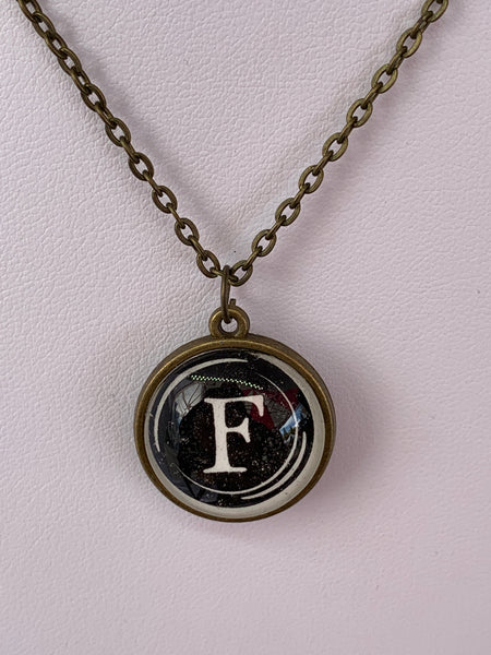 Double Sided Letter Necklace White Text on Black Background