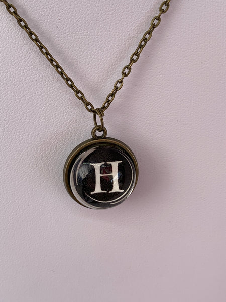 Double Sided Letter Necklace White Text on Black Background