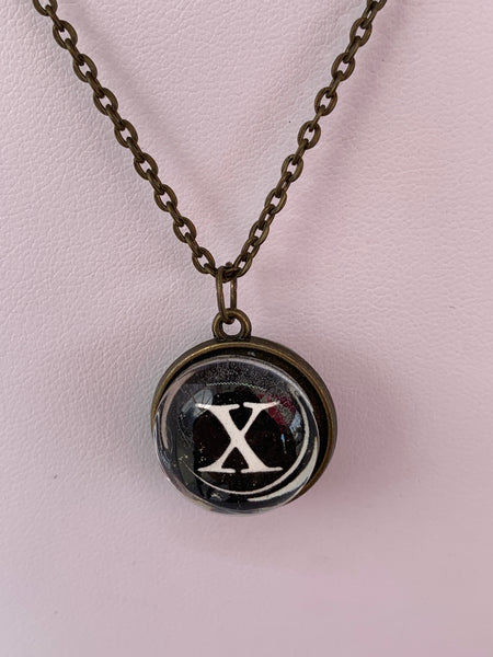 Double Sided Letter Necklace White Text on Black Background