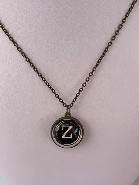 Double Sided Letter Necklace White Text on Black Background