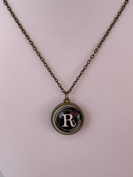 Double Sided Letter Necklace White Text on Black Background