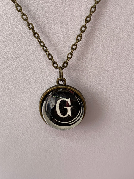 Double Sided Letter Necklace White Text on Black Background