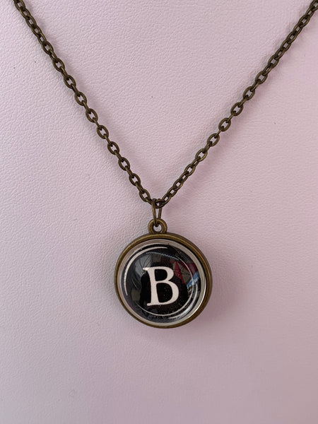 Double Sided Letter Necklace White Text on Black Background