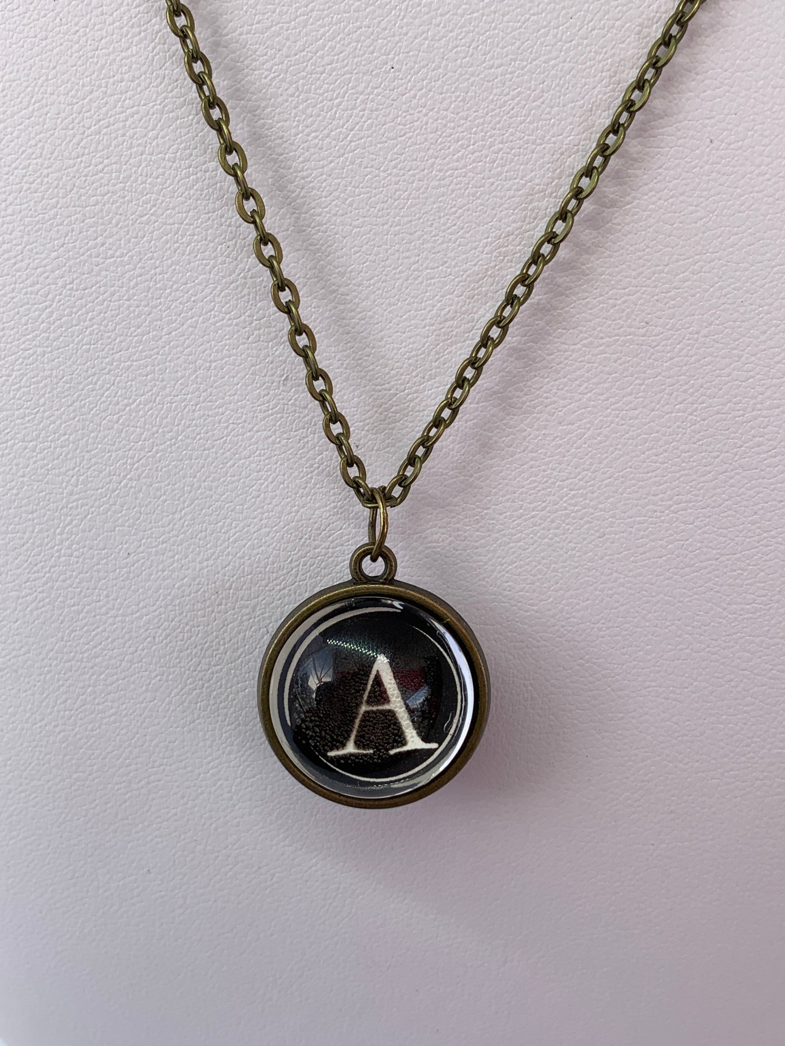 Double Sided Letter Necklace White Text on Black Background