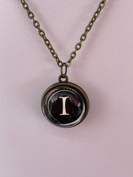 Double Sided Letter Necklace White Text on Black Background
